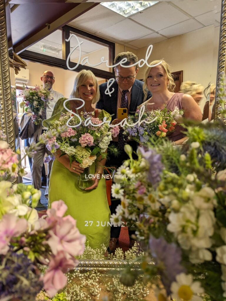 a floor standing mirror with custom vinyl sign for a wedding