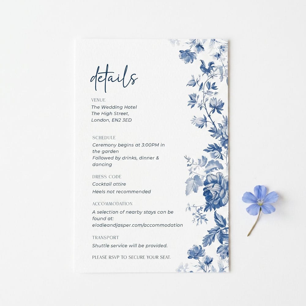 a blue toile de jouy wedding details card on a white background with a simple blue flower