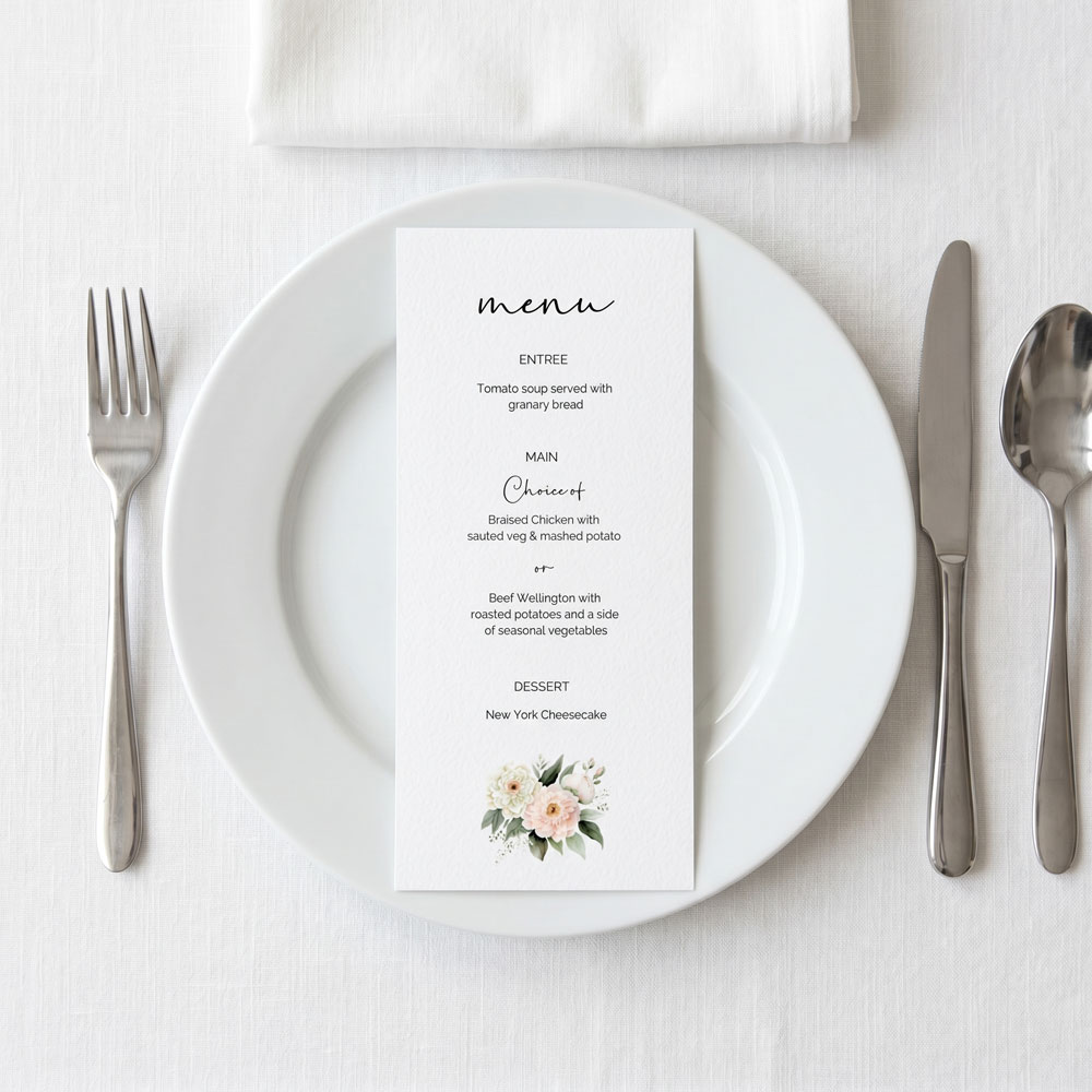 a pretty pink roses wedding menu on a set table