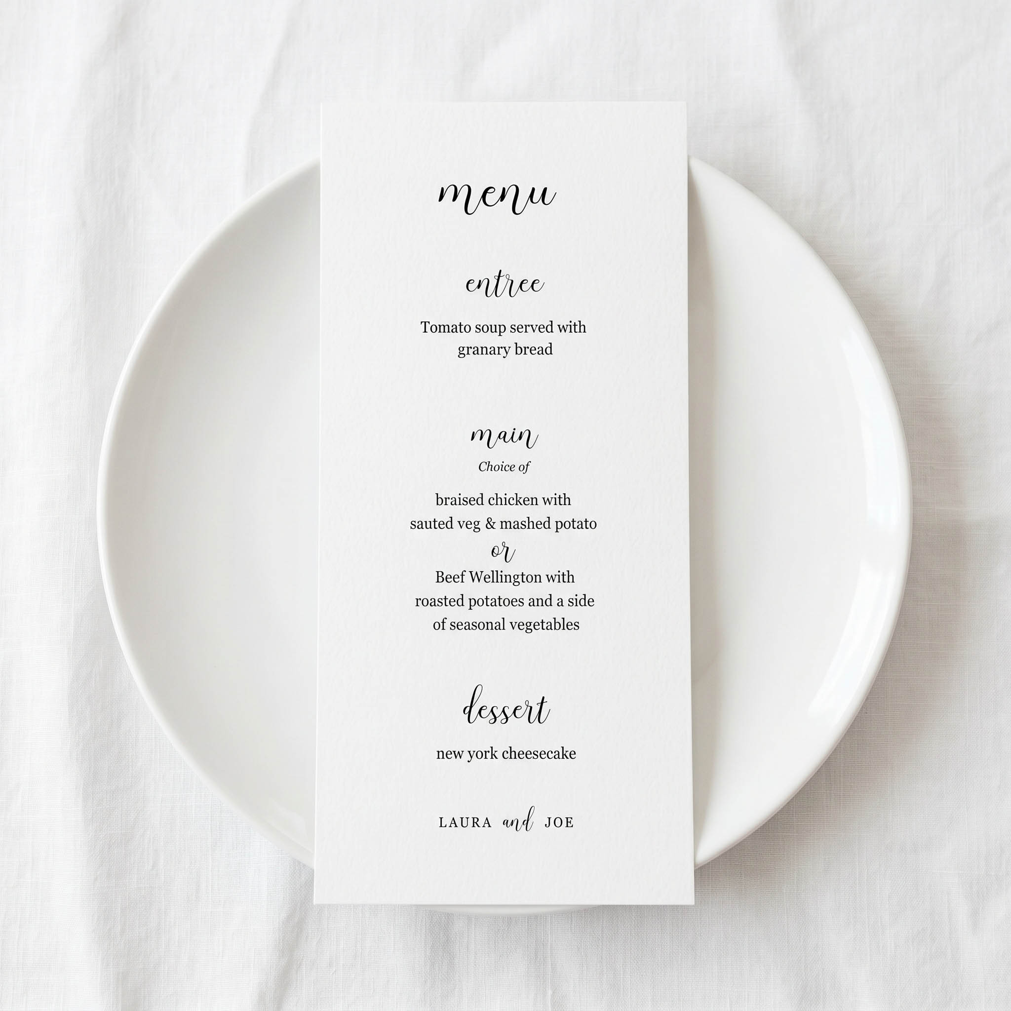 a simple text based wedding menu on a white plate