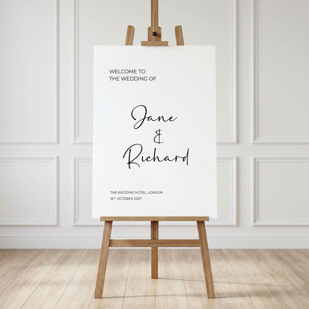 A modern welcome sign on an easel in front of a panelled wall