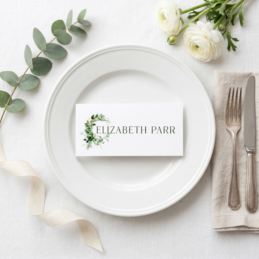 a wedding place card with a green leaf design
