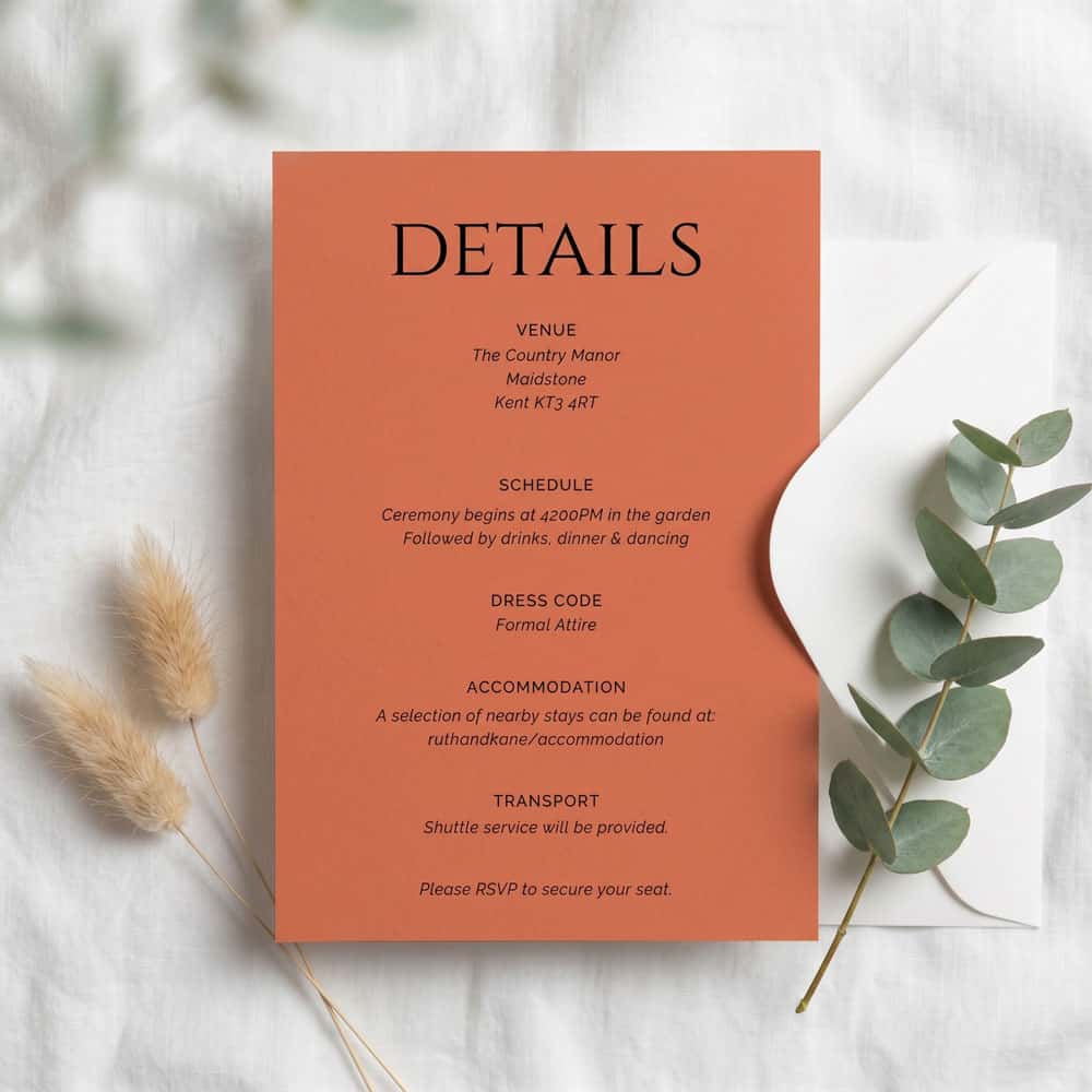 a teal and terracotta details card with white envelope
