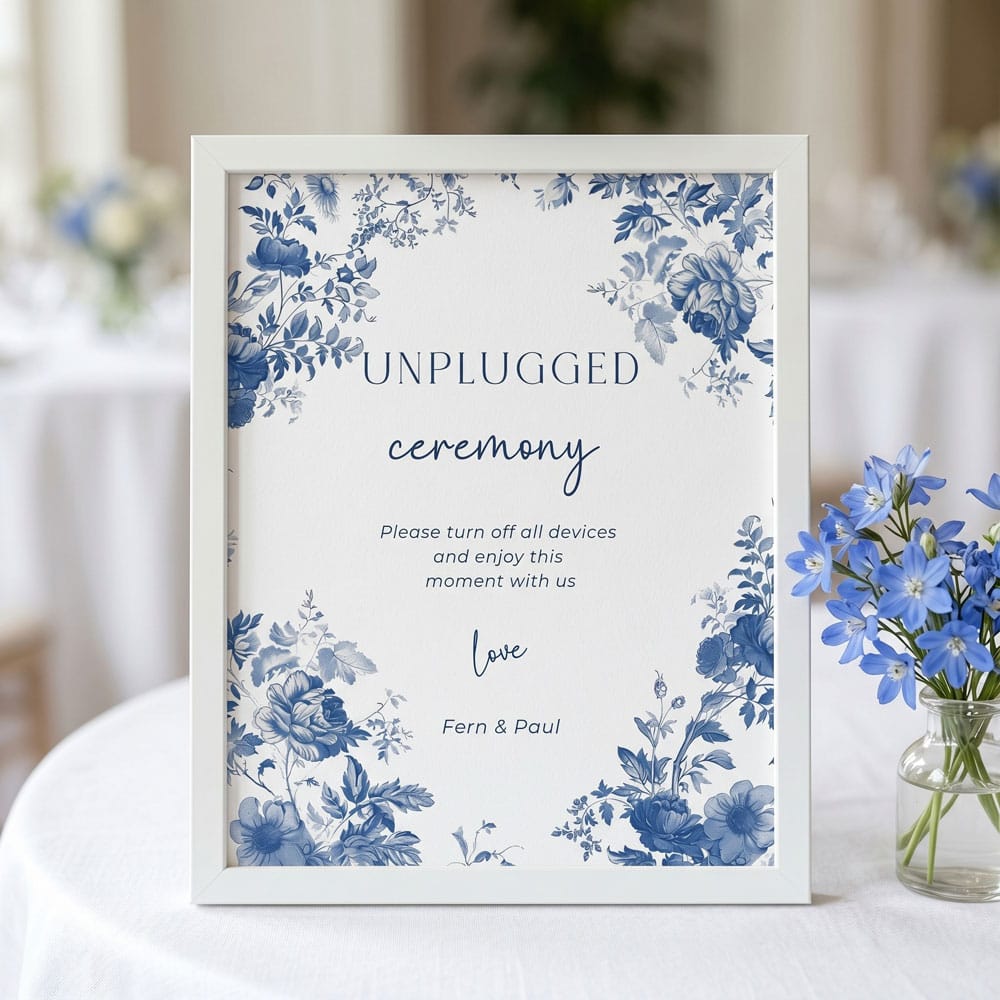 An unplugged ceremony table sign with a blue toile de joy design